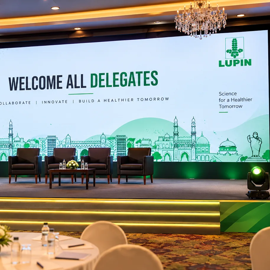 Lupin EnSPIRE 2026 delegate conference stage with a Hyderabad skyline backdrop, panel seating and branded podium by RAW Group